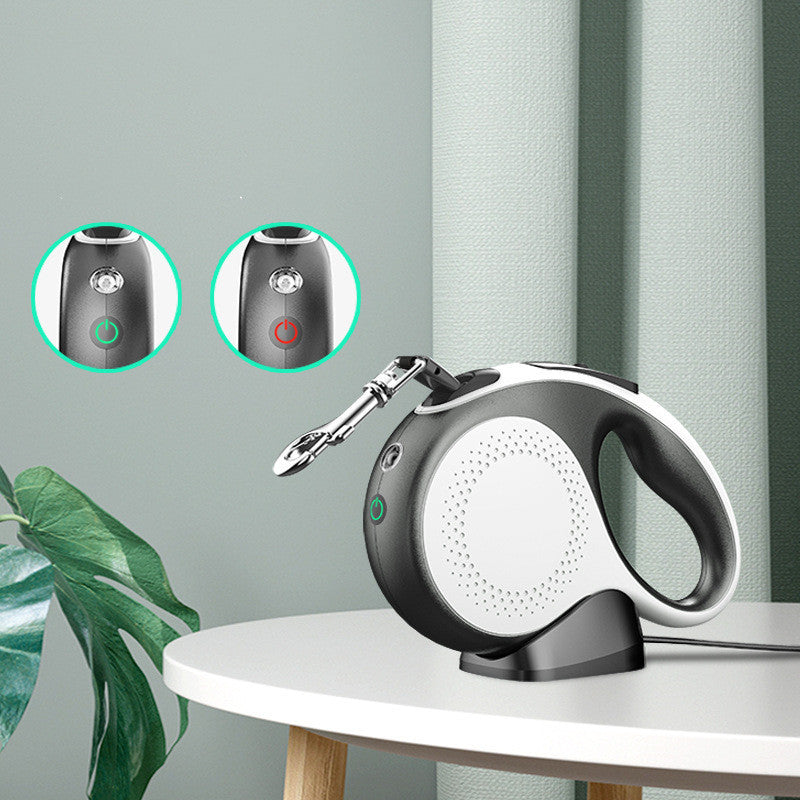Rechargeable pet automatic retractable leash in black and white with metal clip on a table